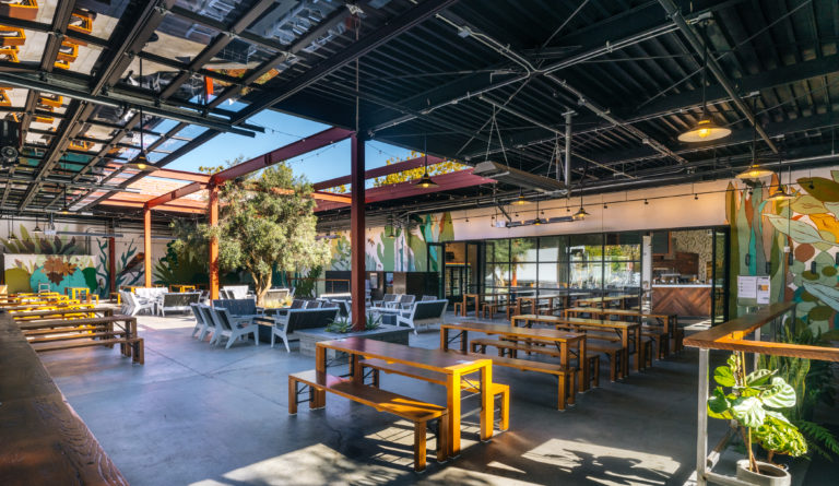 Wide view of the large sunlit indoor/outdoor space at the San Leandro taproom